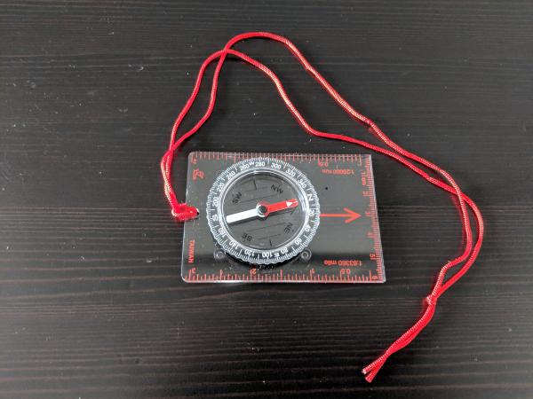 compass with string attached to it.